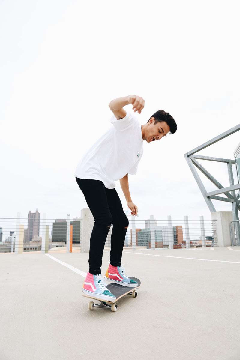 Man skateboards in colorful shoes